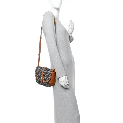 Belvedere II PM messenger bag worn at side view, Goyardine pattern with brown strap