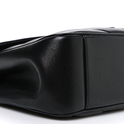 Black leather shoulder bag corner with topstitching and smooth side panel