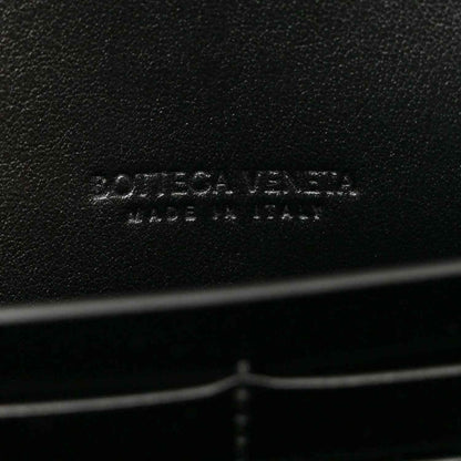 Bottega Veneta leather clutch brand imprint on black leather