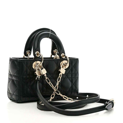 Black quilted lambskin micro handbag with top handles and detachable crossbody strap