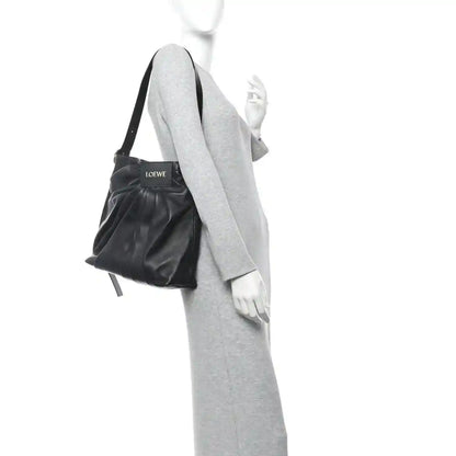 Black leather draped mini tote with shoulder strap and LOEWE logo