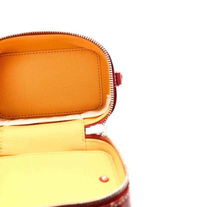 Red vanity case with gold-tone zipper and visible interior lining