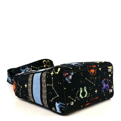 Medium canvas handbag, black with colorful zodiac pixel stars, blue stripe, zip closure