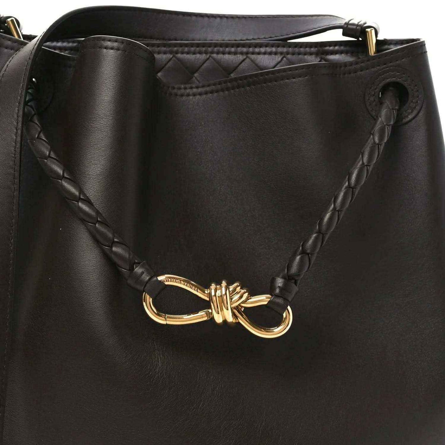 Small bucket bag in dark leather with braided side detail and gold-tone clasp