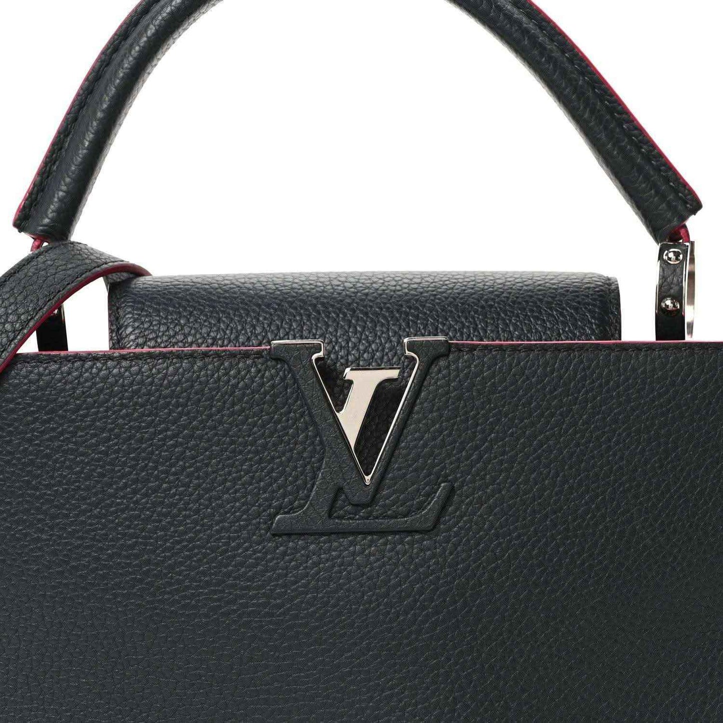 Louis Vuitton Capucines PM leather bag front close-up, dark blue with LV emblem and fuchsia piping