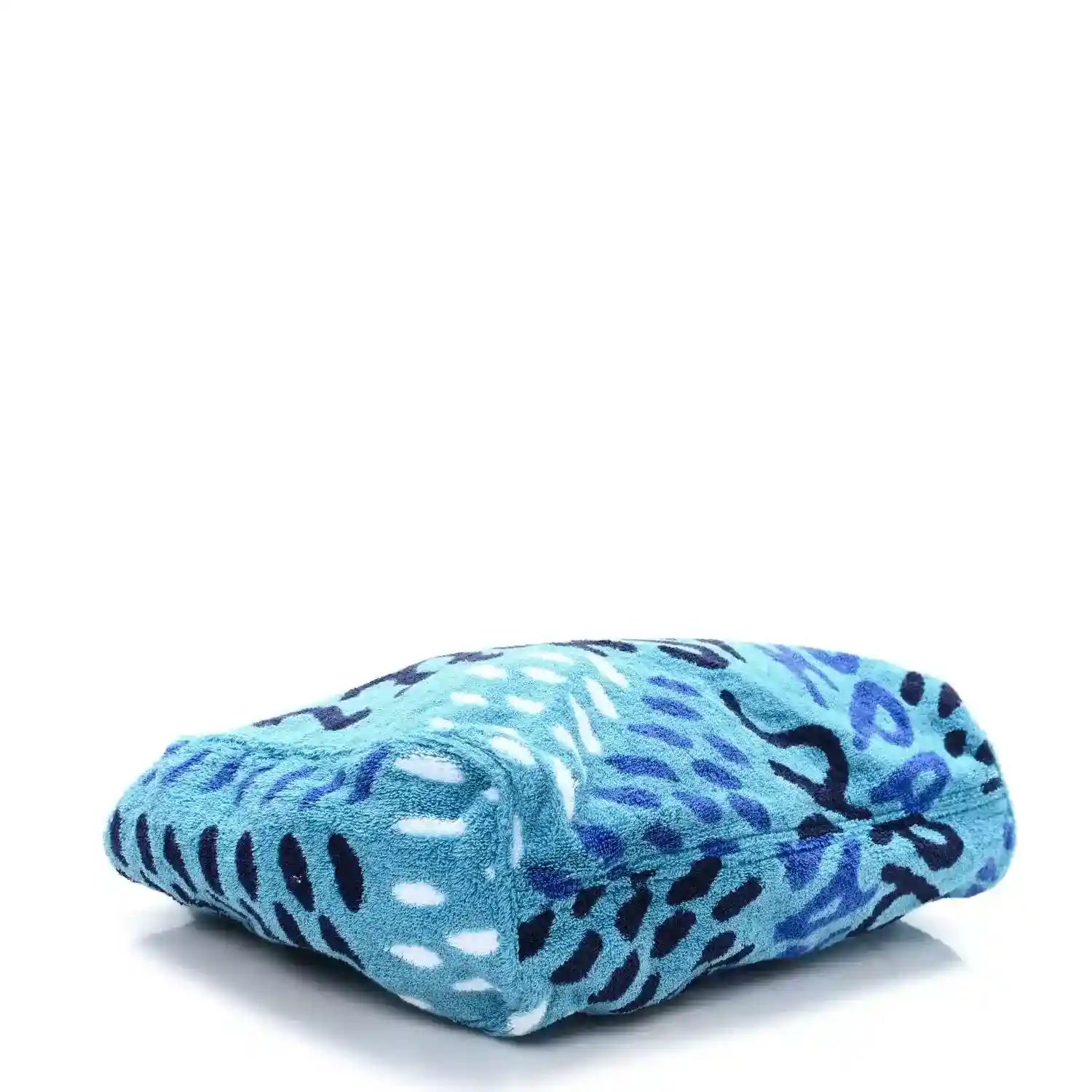 Folded turquoise terry beach tote with black-and-white abstract animal graphic print.