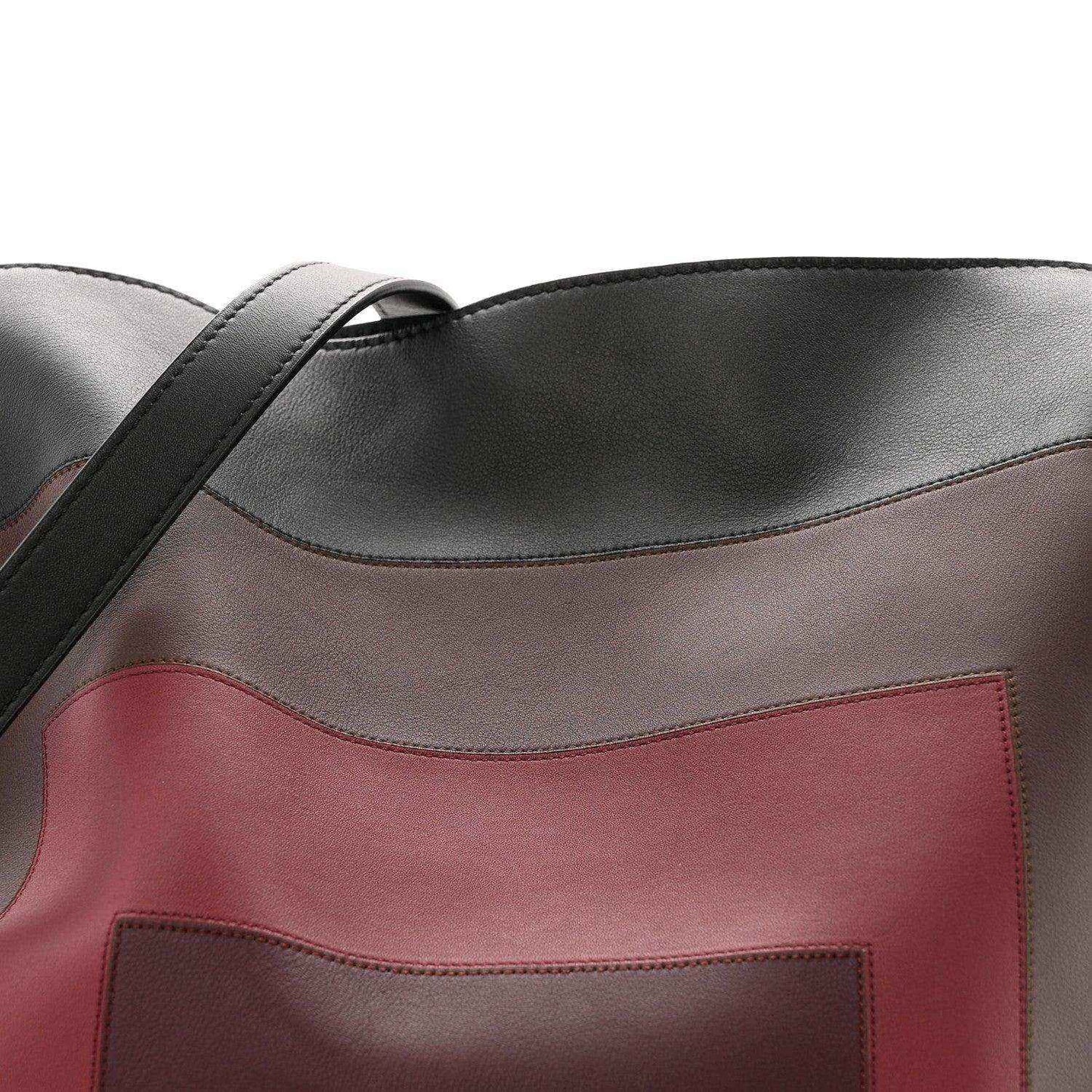 Black clutch with burgundy center panel and stitched edge detail