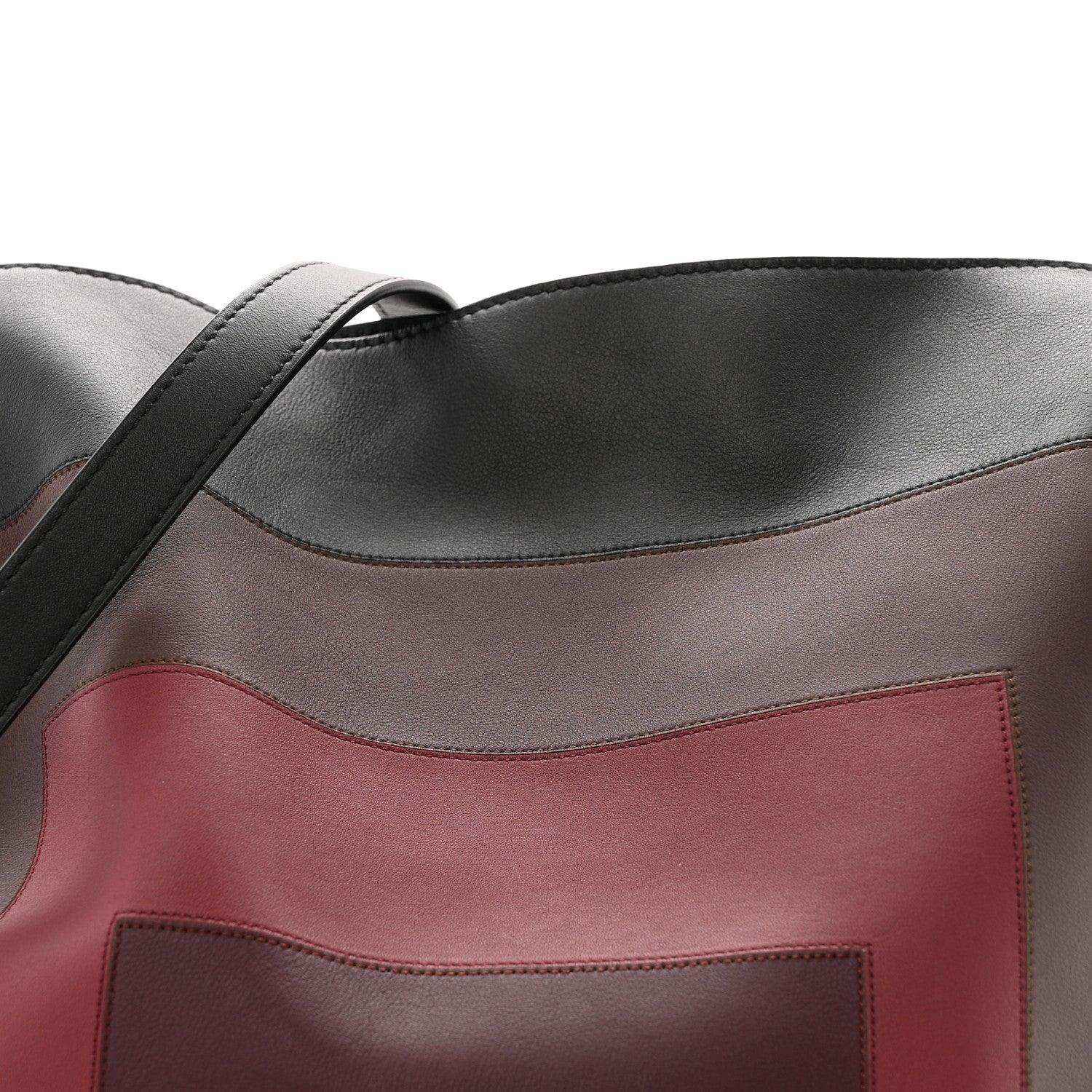 Black clutch with burgundy center panel and stitched edge detail