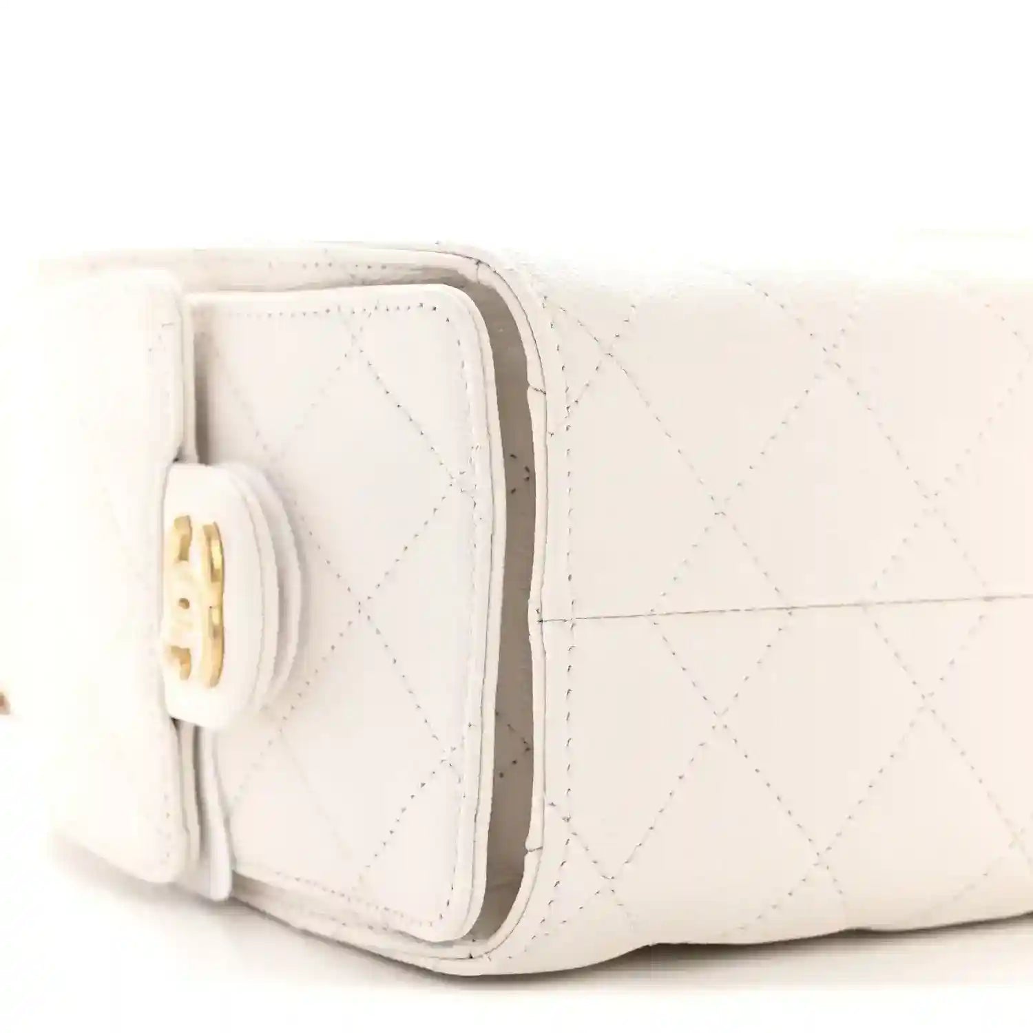 White quilted mini handbag side with fold-over flap and gold clasp hardware