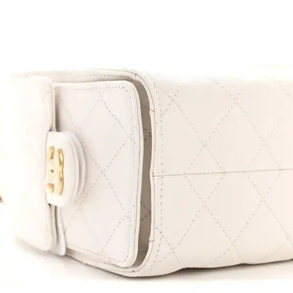 White quilted mini handbag side with fold-over flap and gold clasp hardware