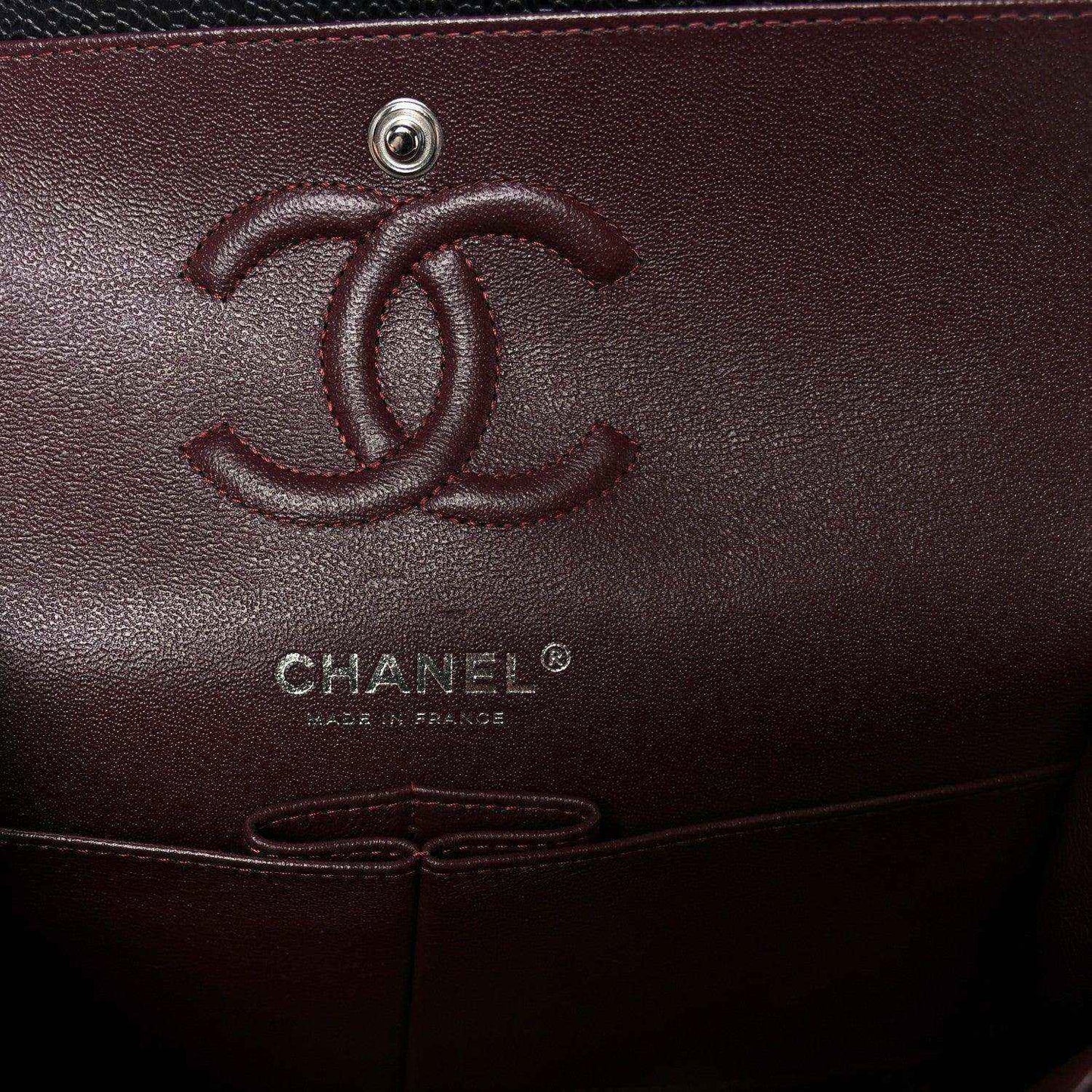 Chanel logo emboss on burgundy interior pocket of a flap bag