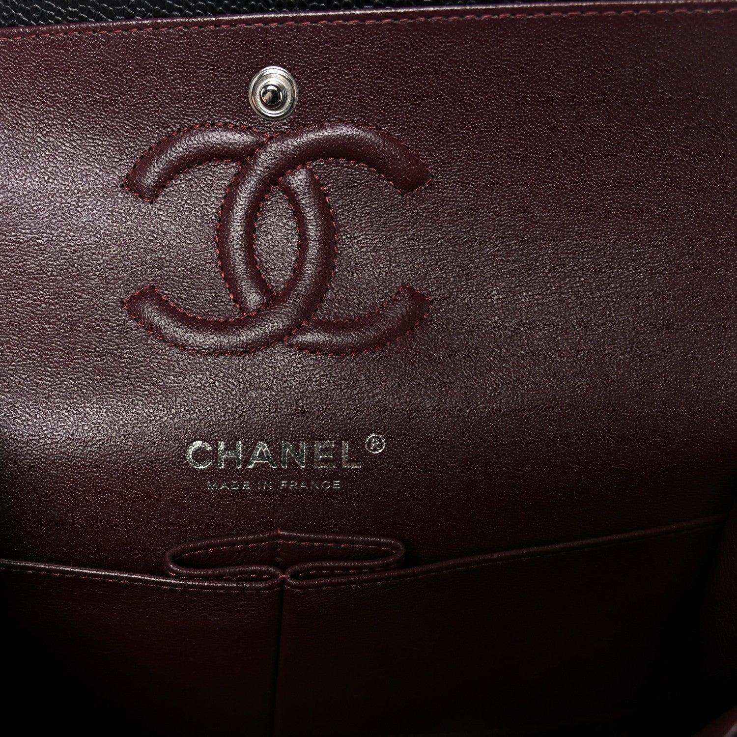 Chanel logo emboss on burgundy interior pocket of a flap bag