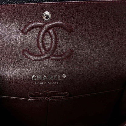Chanel logo emboss on burgundy interior pocket of a flap bag