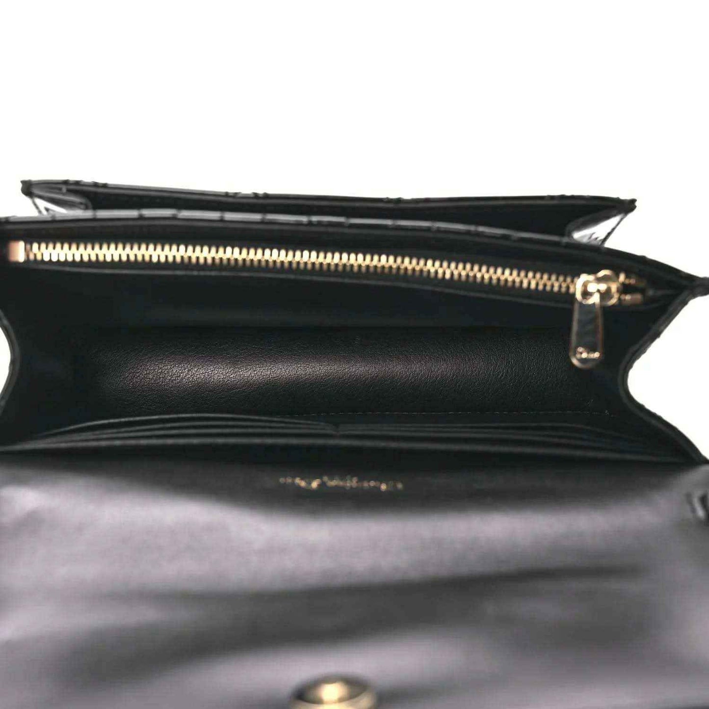 Black patent cannage Lady Dior pouch interior with gold zipper and side seam