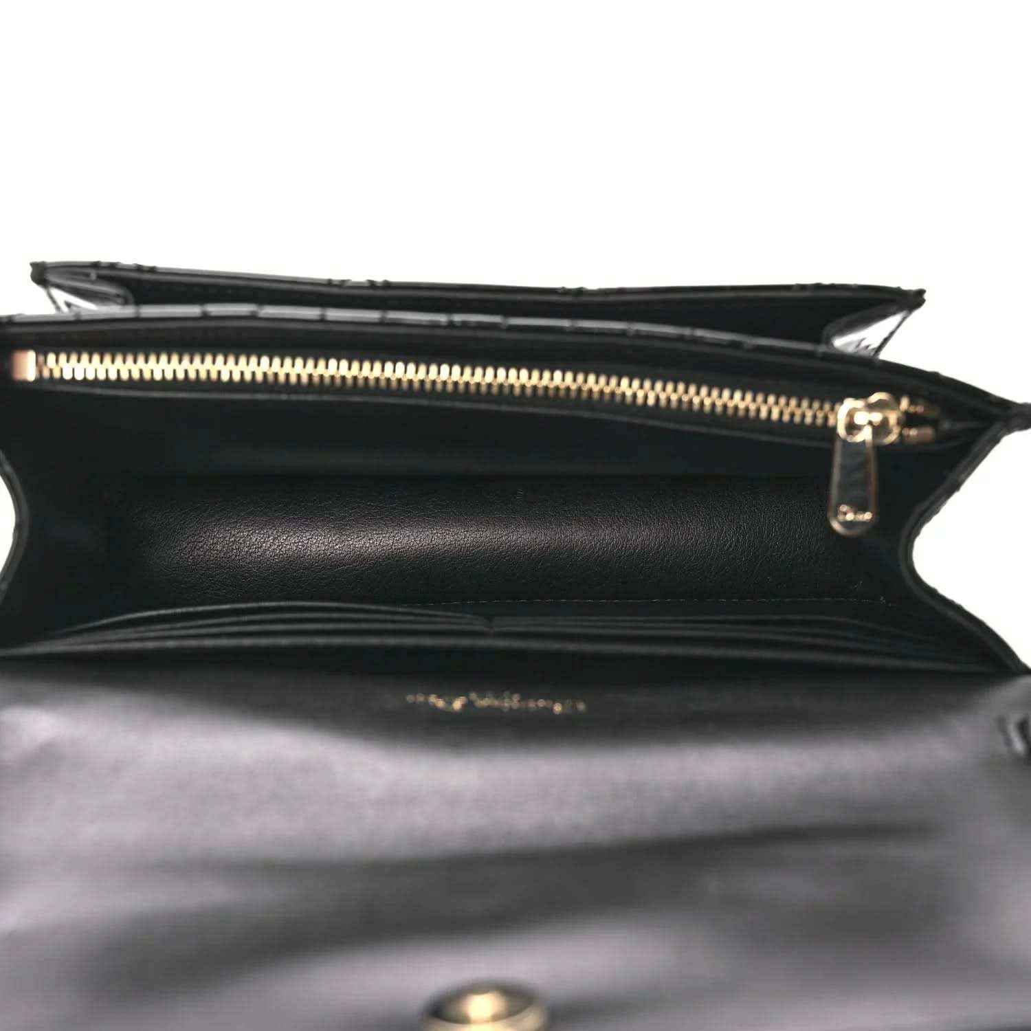 Black patent cannage Lady Dior pouch interior with gold zipper and side seam