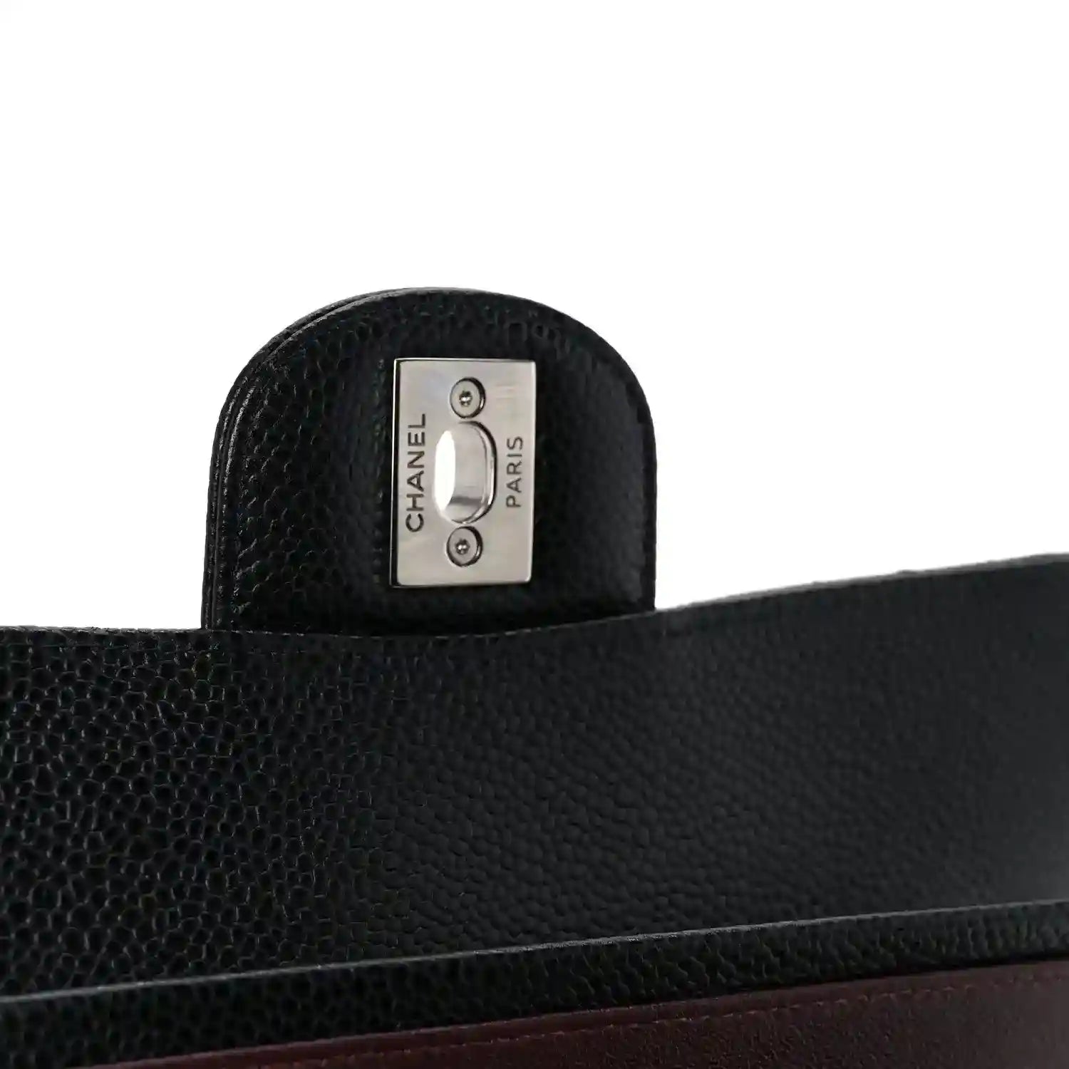 Chanel Paris label on black leather interior panel with caviar texture