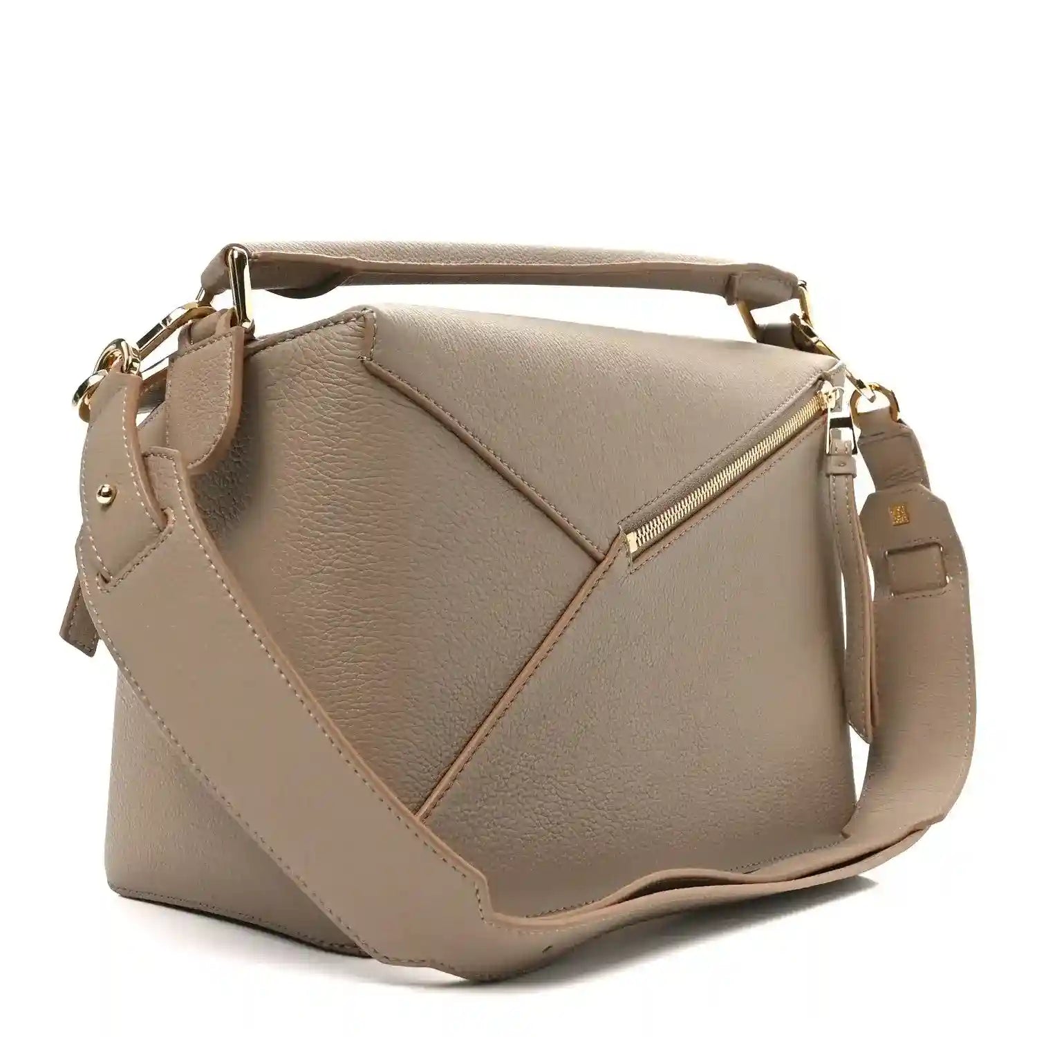Sand leather bag front with crossbody strap, diagonal seams, and gold-tone zipper pull.