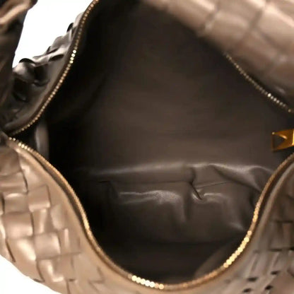 Taupe leather hobo bag interior with smooth lining and gold-tone zipper trim