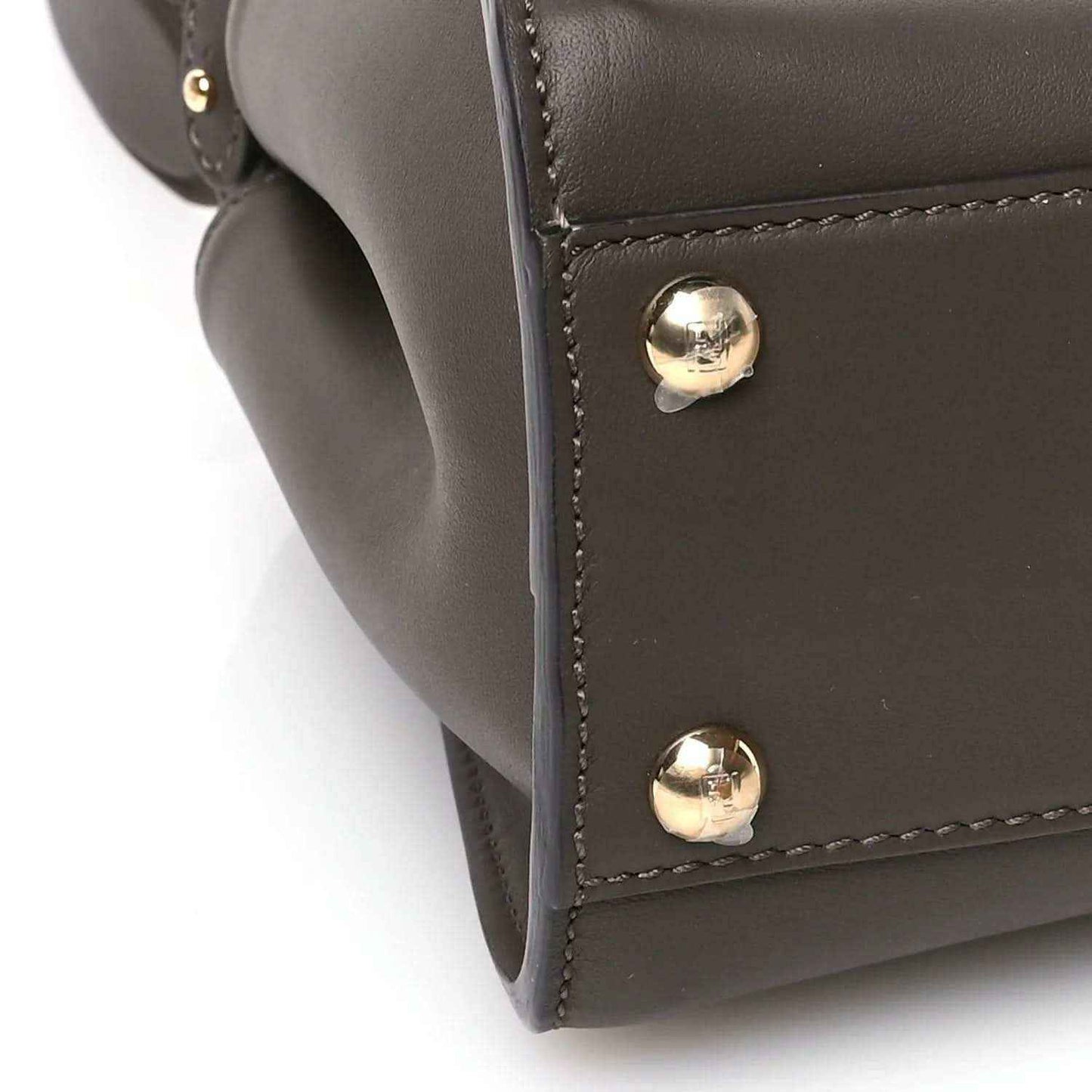 Mini satchel corner in dark brown leather with two gold snap studs.