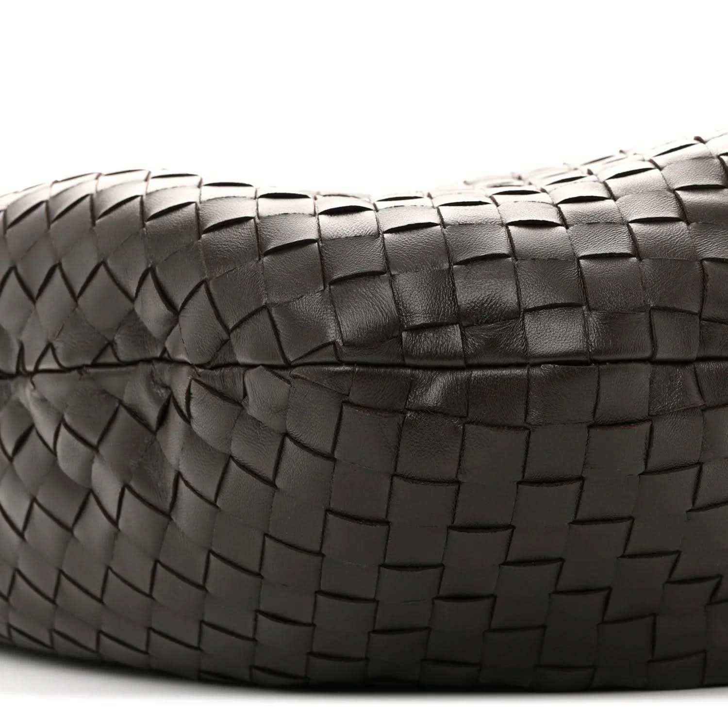 Close-up of intrecciato leather weave on the bag with stitched border detail