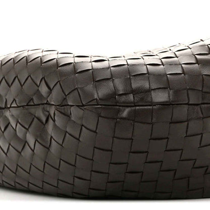 Close-up of intrecciato leather weave on the bag with stitched border detail