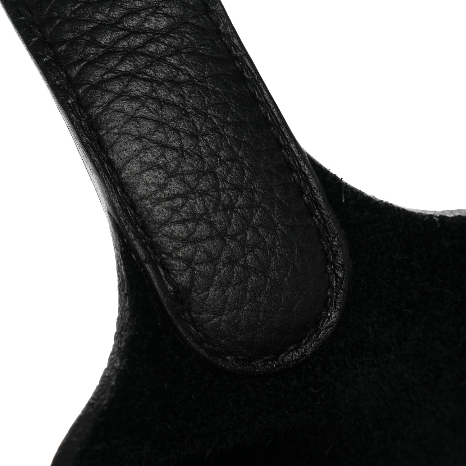 Black pebbled leather tote handle close-up, curved opening