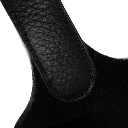 Black pebbled leather tote handle close-up, curved opening