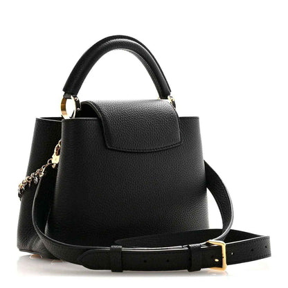 Black leather handbag with top handle, crossbody strap, and gold LV logo