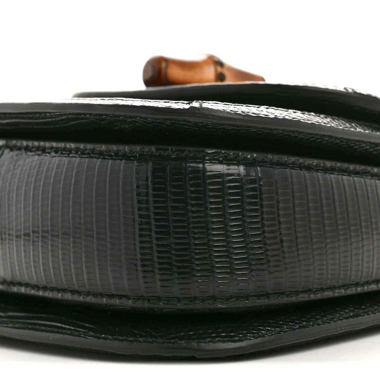 Gucci mini top handle bag side edge close-up, black embossed leather texture and trim