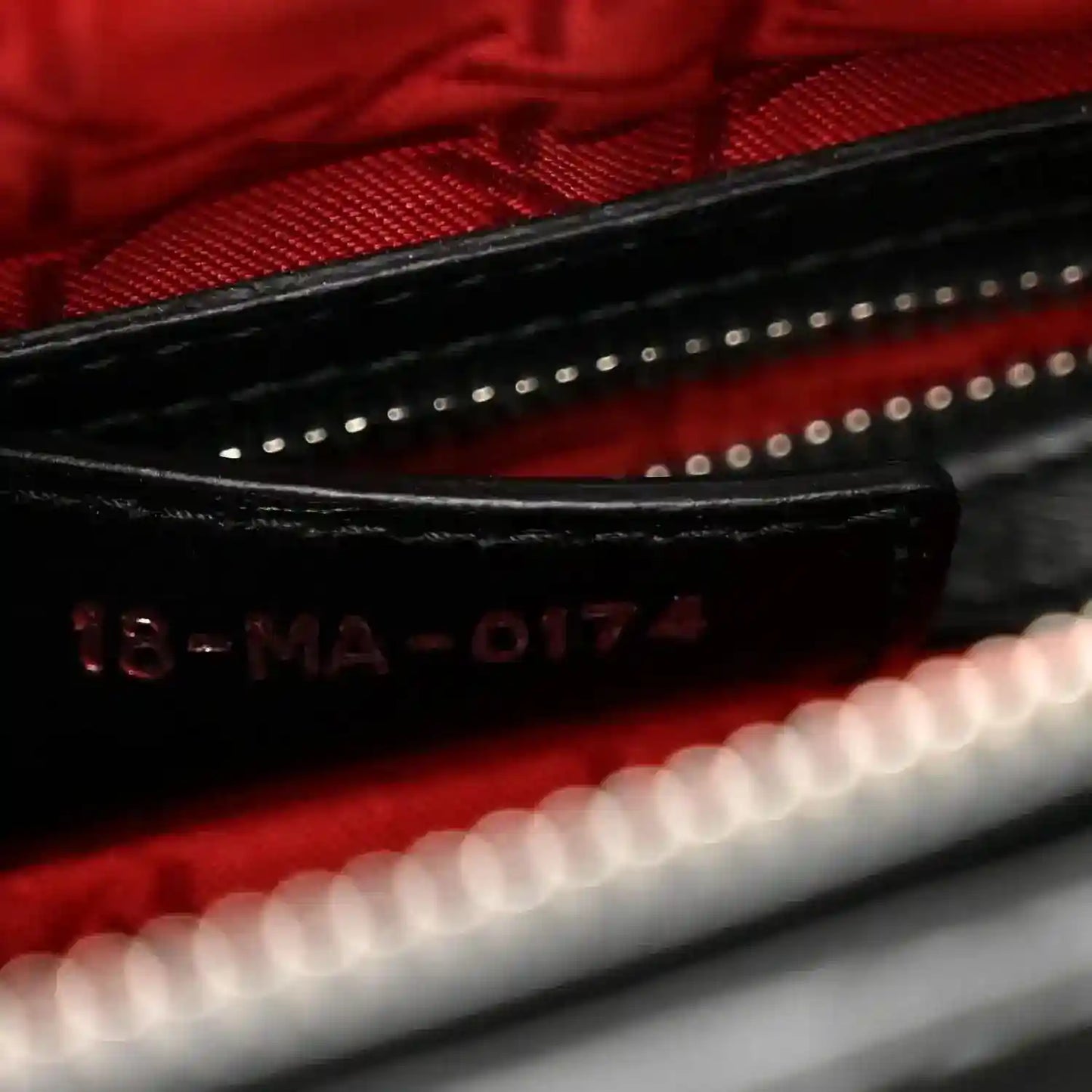 Lady Dior handbag interior close-up showing red lining and code “16-MA-0174”
