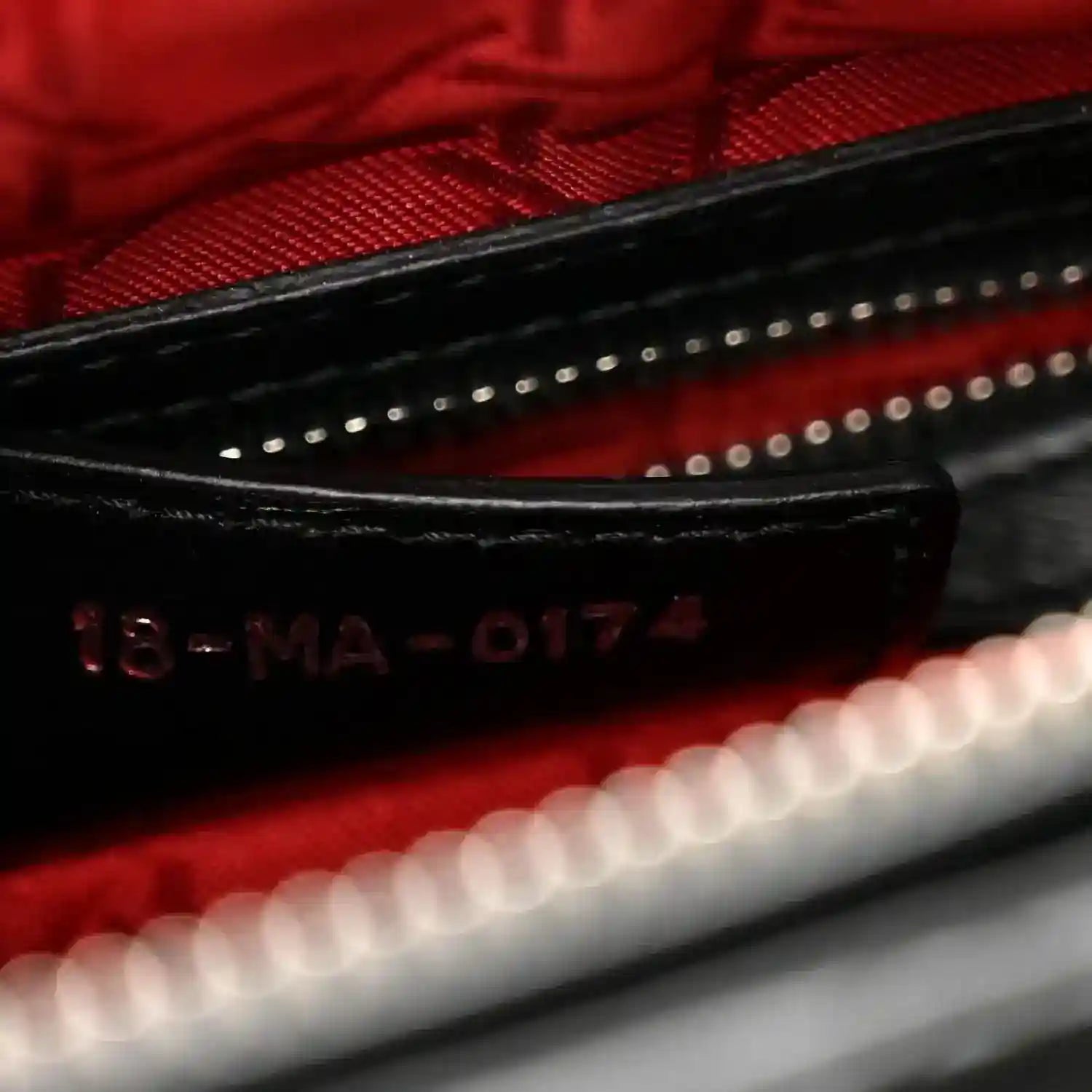 Lady Dior handbag interior close-up showing red lining and code “16-MA-0174”