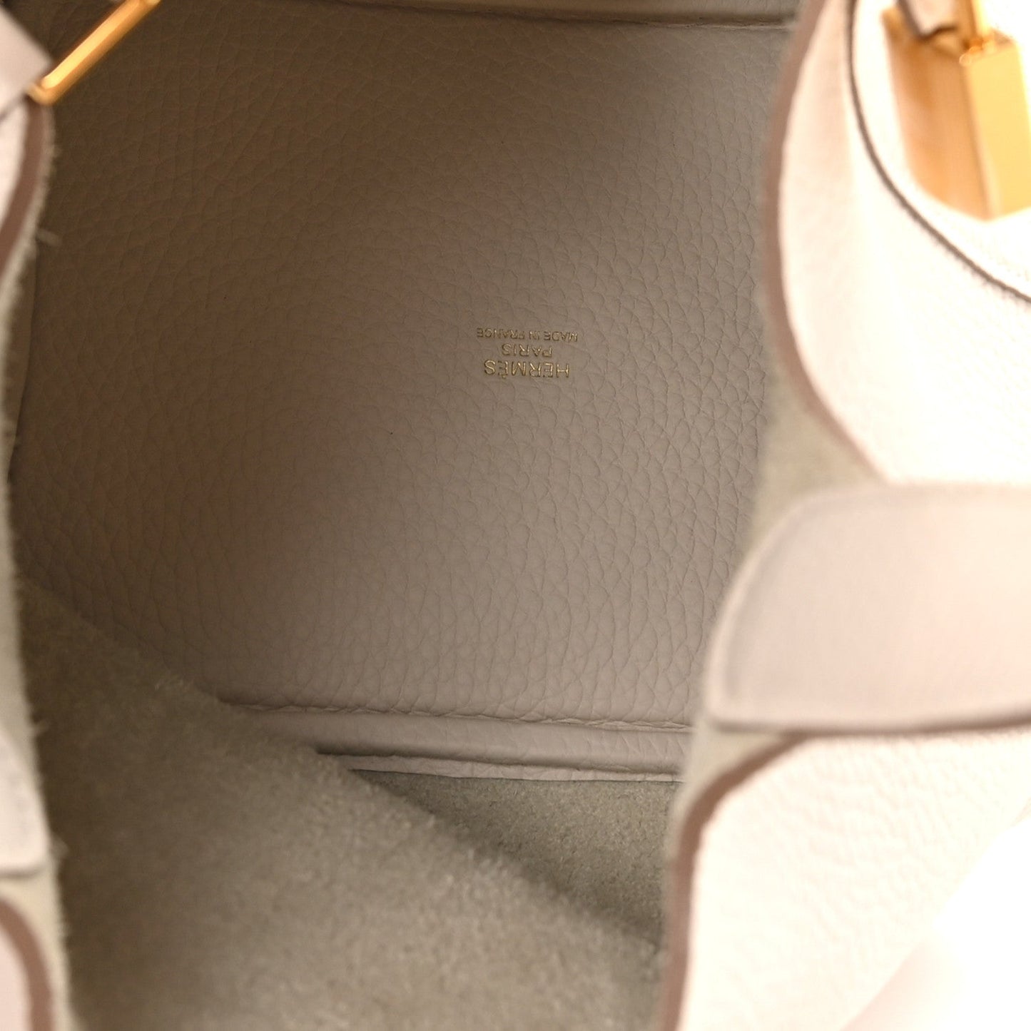 Pale cream leather interior panel with small embossed text