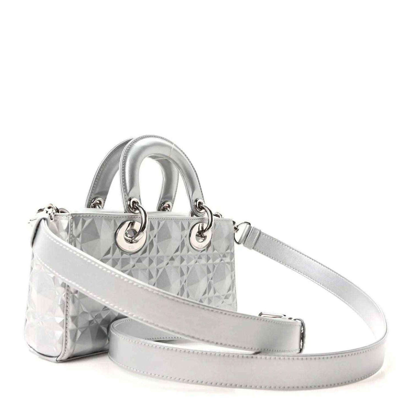 Small metallic silver handbag with geometric canage texture, top handles, and crossbody strap.