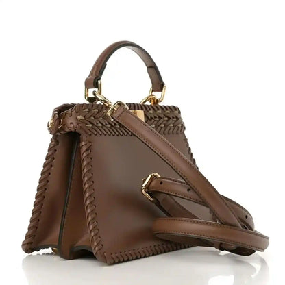 Brown woven leather satchel with top handle and front strap detail with gold hardware