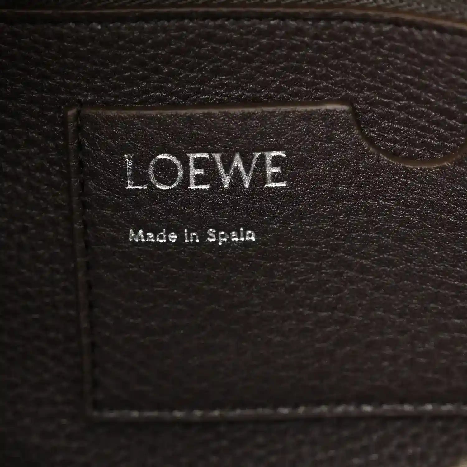 Loewe leather bag label reading 'LOEWE' and 'Made in Spain'