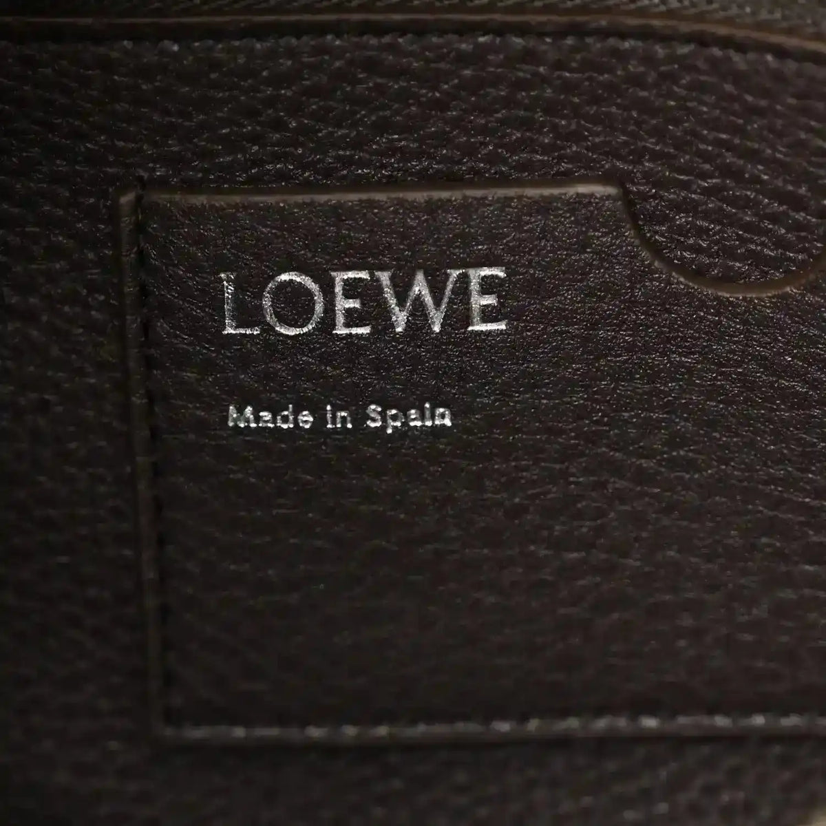 Loewe leather bag label reading 'LOEWE' and 'Made in Spain'