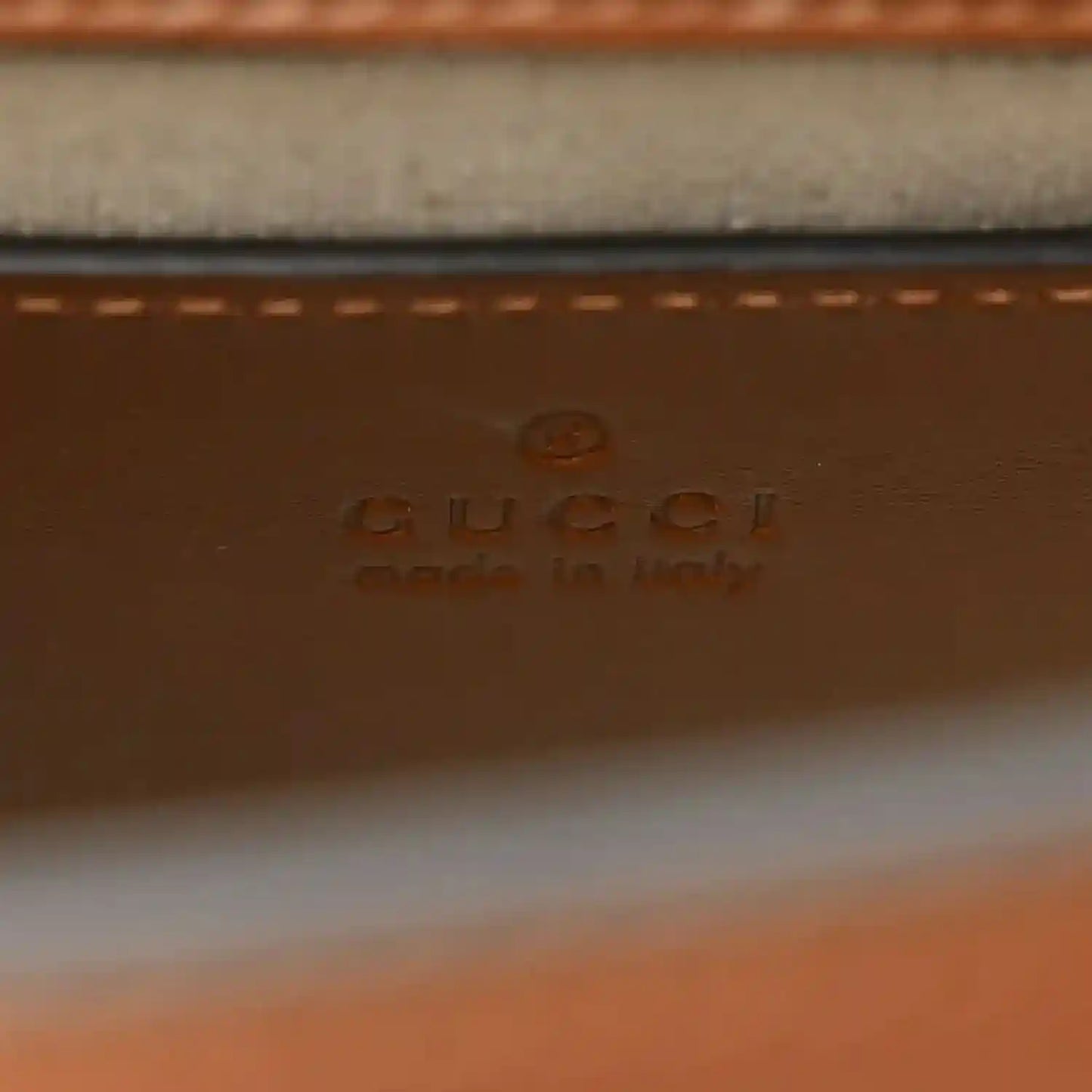 Gucci leather label on mini tote bag with stamped branding