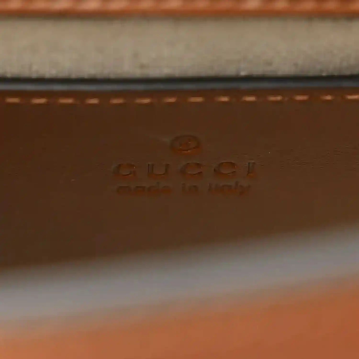 Gucci leather label on mini tote bag with stamped branding