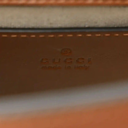 Gucci leather label on mini tote bag with stamped branding