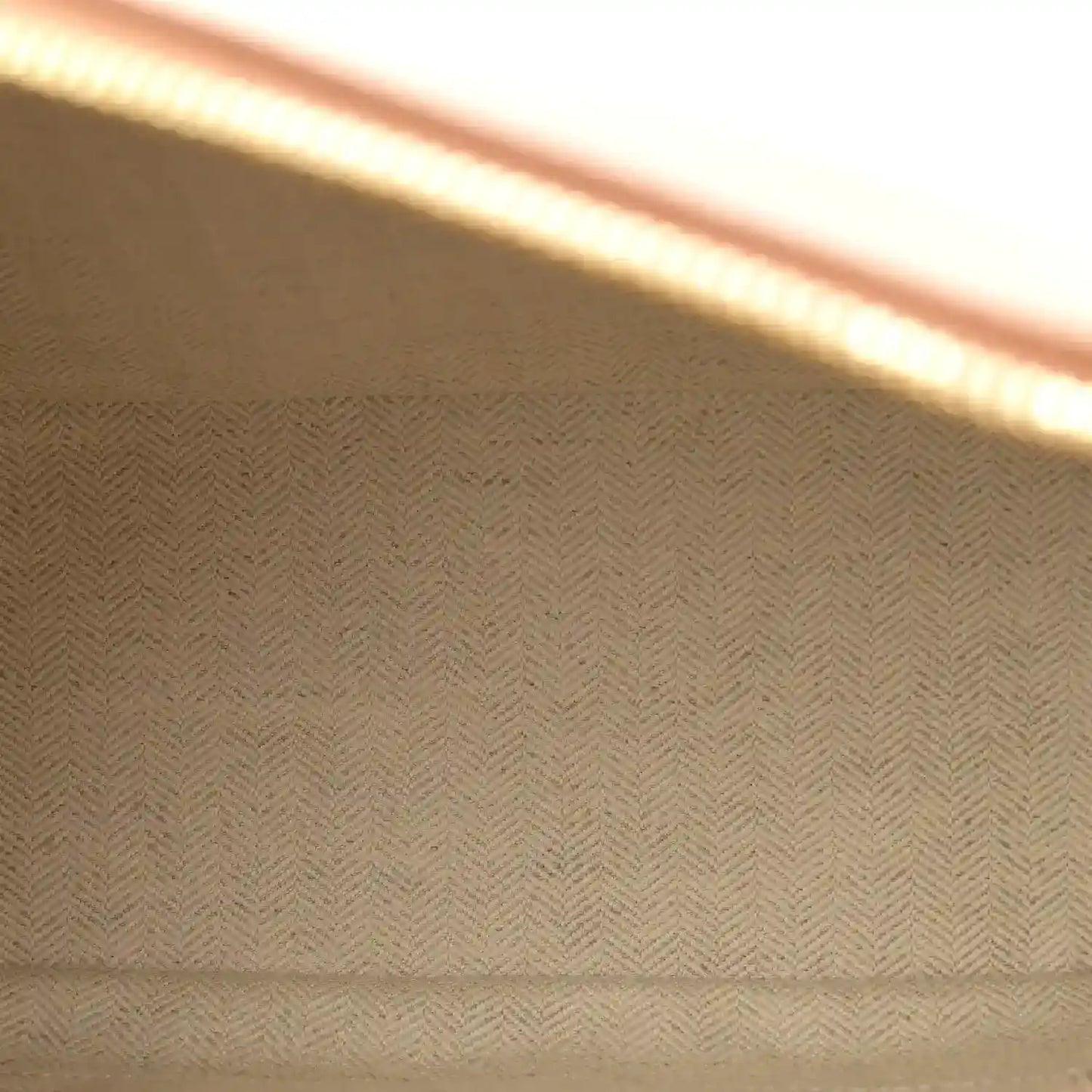 Herringbone fabric lining panel inside the bag