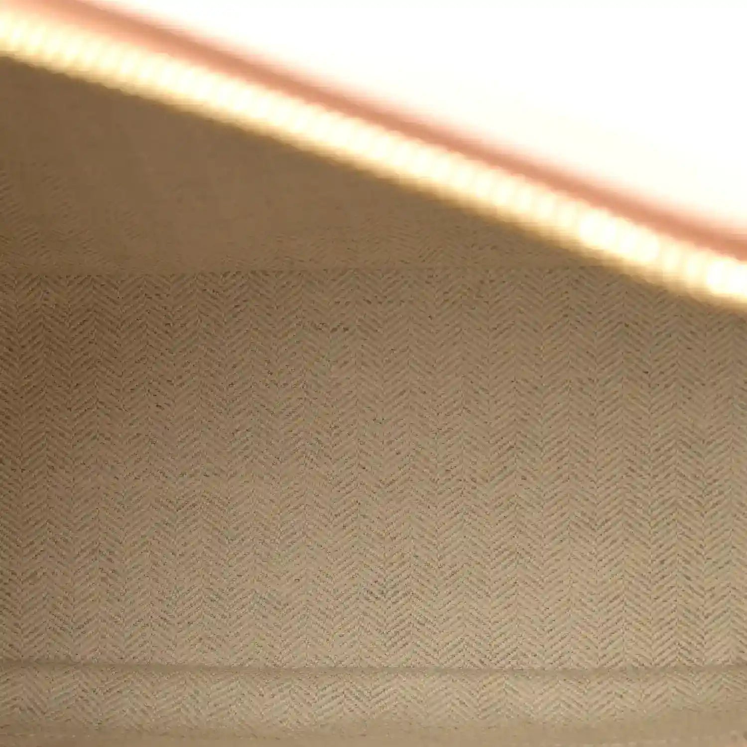 Herringbone fabric lining panel inside the bag