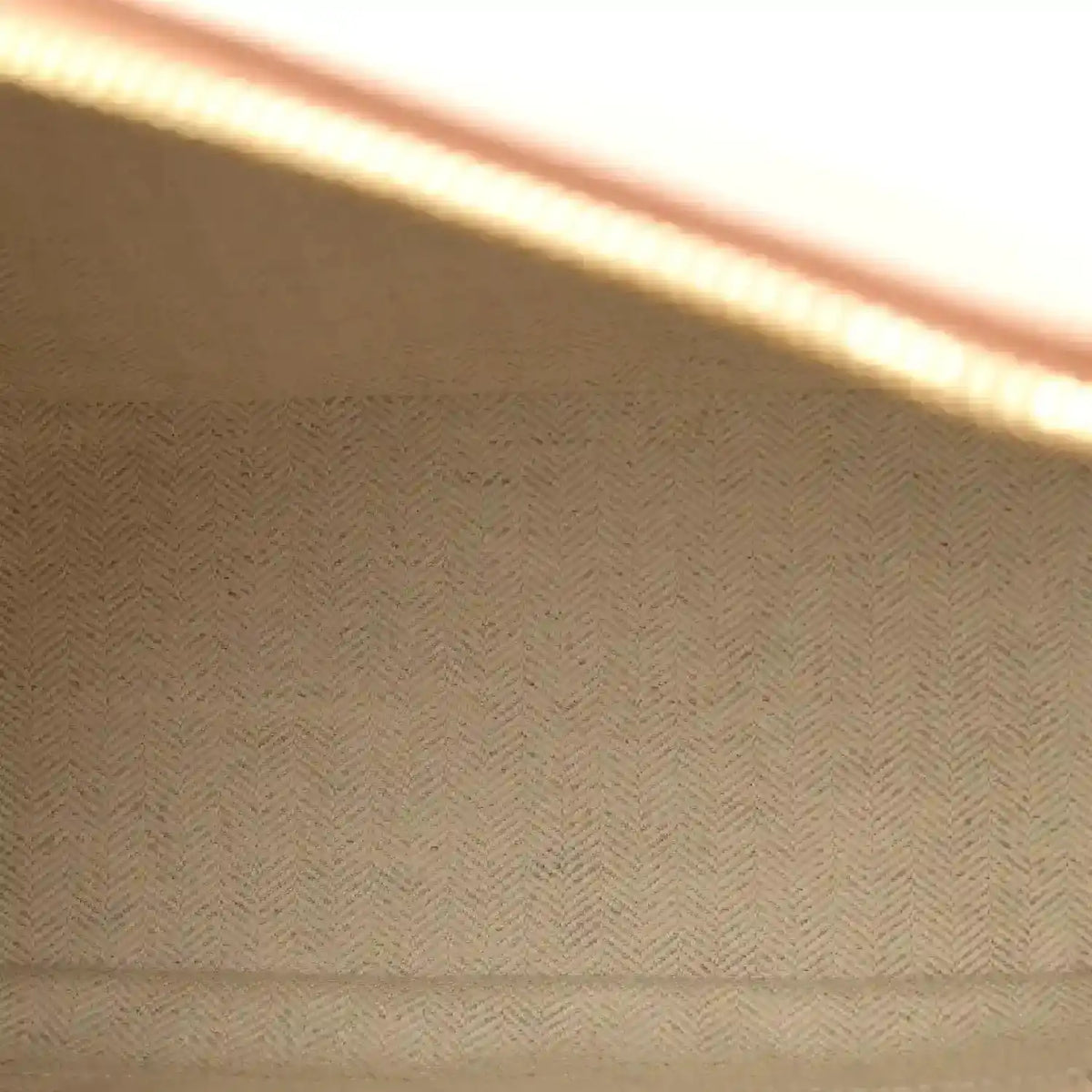 Herringbone fabric lining panel inside the bag