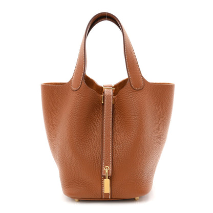 Tan leather bucket bag with central lock zip and gold-tone hardware