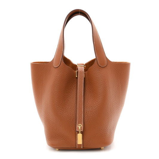 Tan leather bucket bag with central lock zip and gold-tone hardware