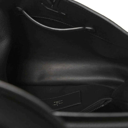 Black leather handbag interior view with zipper and stitched lining