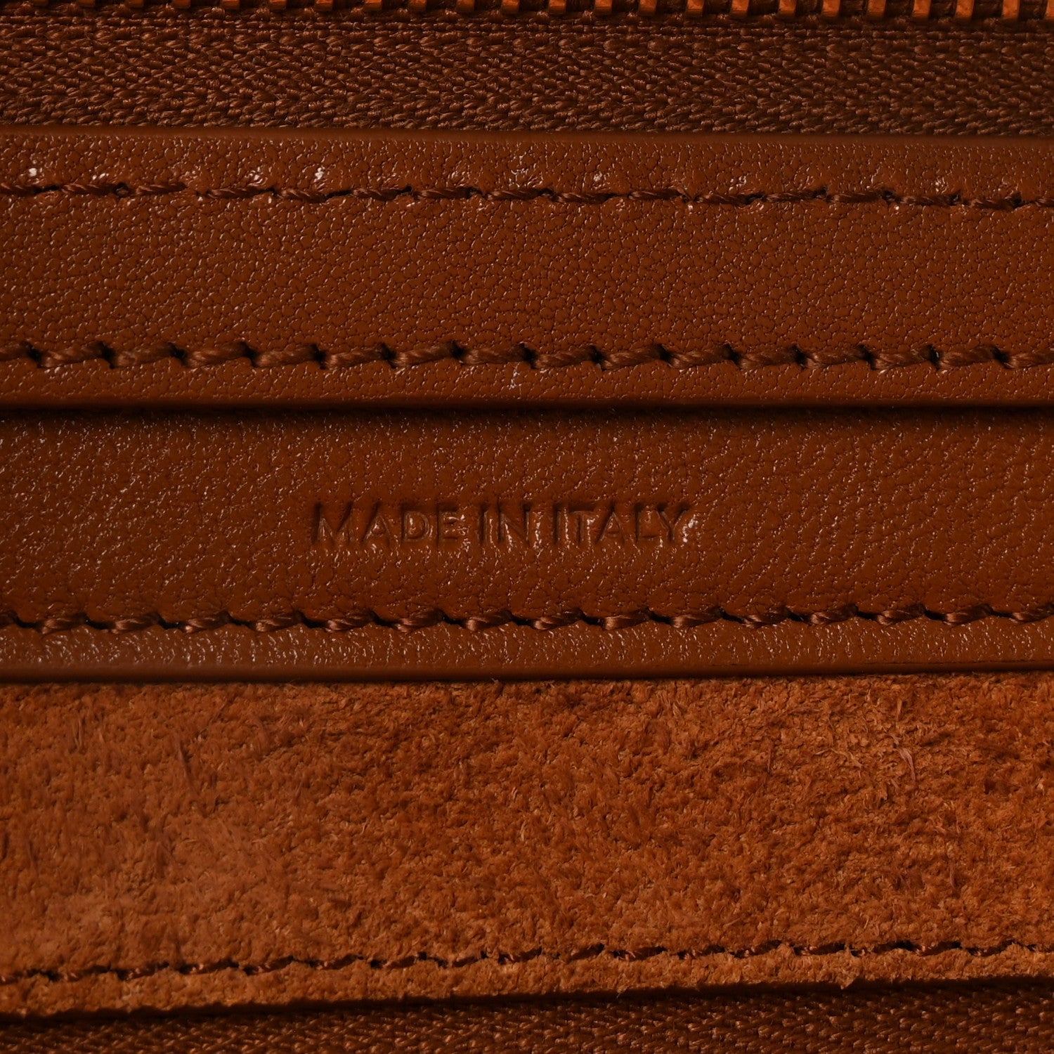 Leather branding and stitching with “MADE IN ITALY” on tan panel