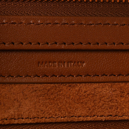 Leather branding and stitching with “MADE IN ITALY” on tan panel