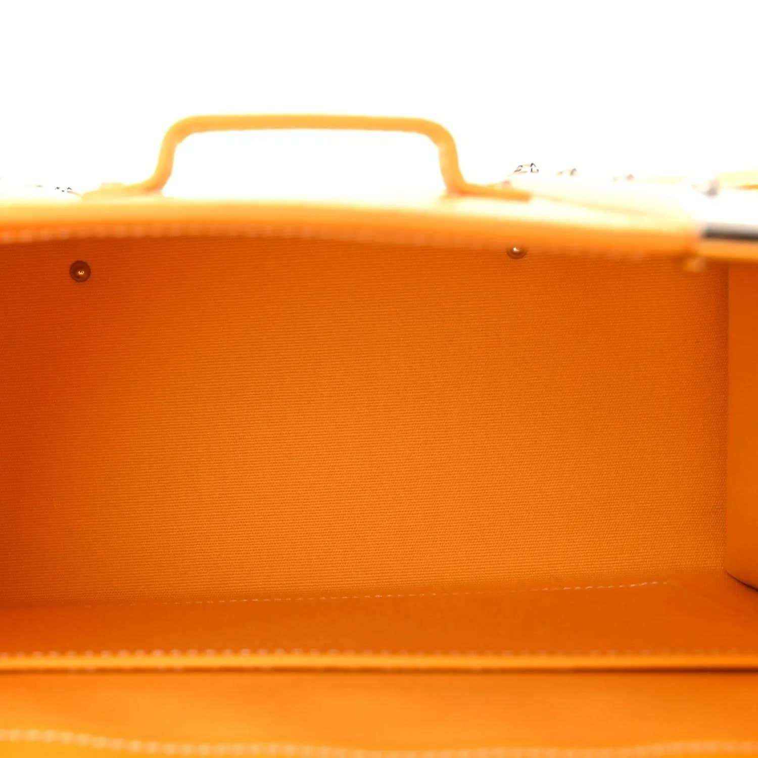 Interior view of yellow canvas bag with top handle and smooth lined compartment.