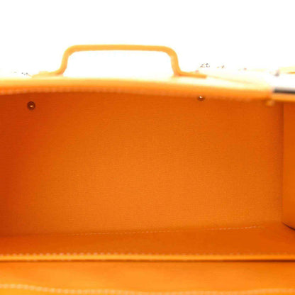 Interior view of yellow canvas bag with top handle and smooth lined compartment.