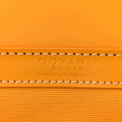 Close-up of yellow canvas edge with embossed brand text and contrast stitched trim.